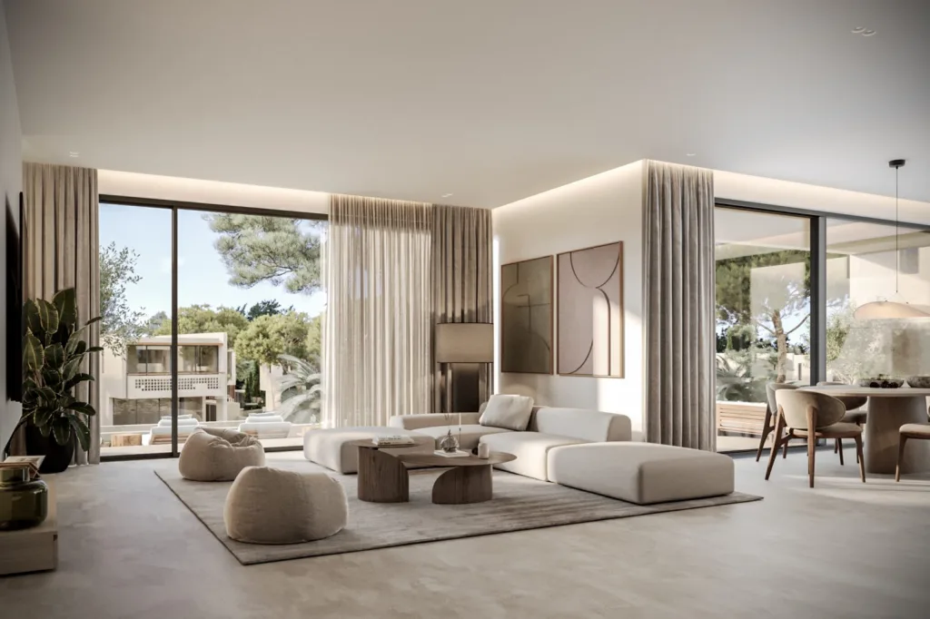 Phòng khách tông be với sofa tròn thấp, rèm vải mỏng buông dọc vách kính, phía sau là bàn ăn và cây xanh ngoài hiên.