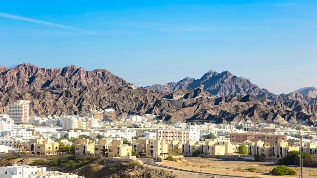 Apartment and office blocks in Muscat below the Hajar mountains, Oman