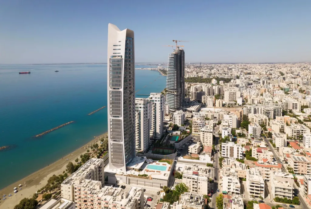 Aerial view of the ONE tower beside the beach and the Limassol coastline