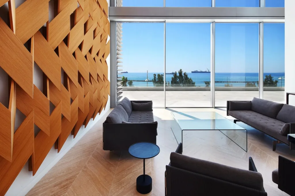 Residents' lounge with a woven timber wall and sea view