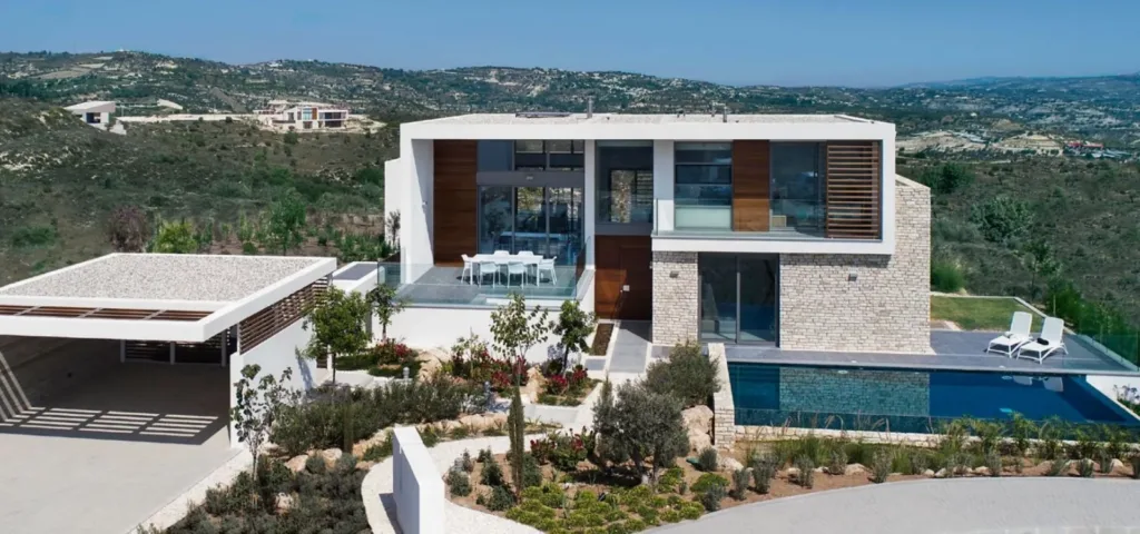 Asteria residence: two-storey stone and white villa with an overflow pool above the hills