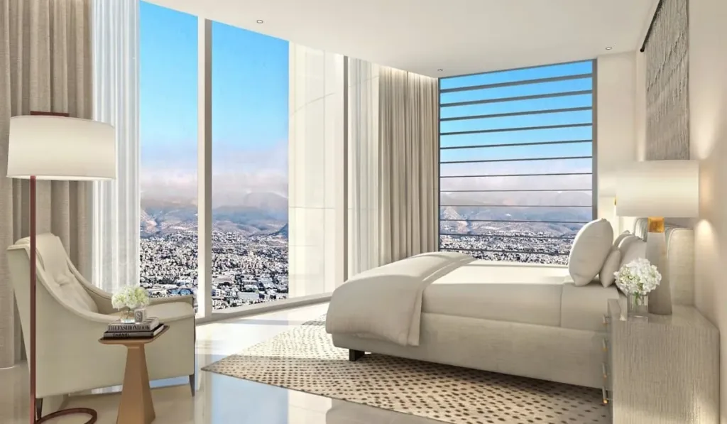 Bedroom with floor-to-ceiling windows overlooking Limassol and the mountains