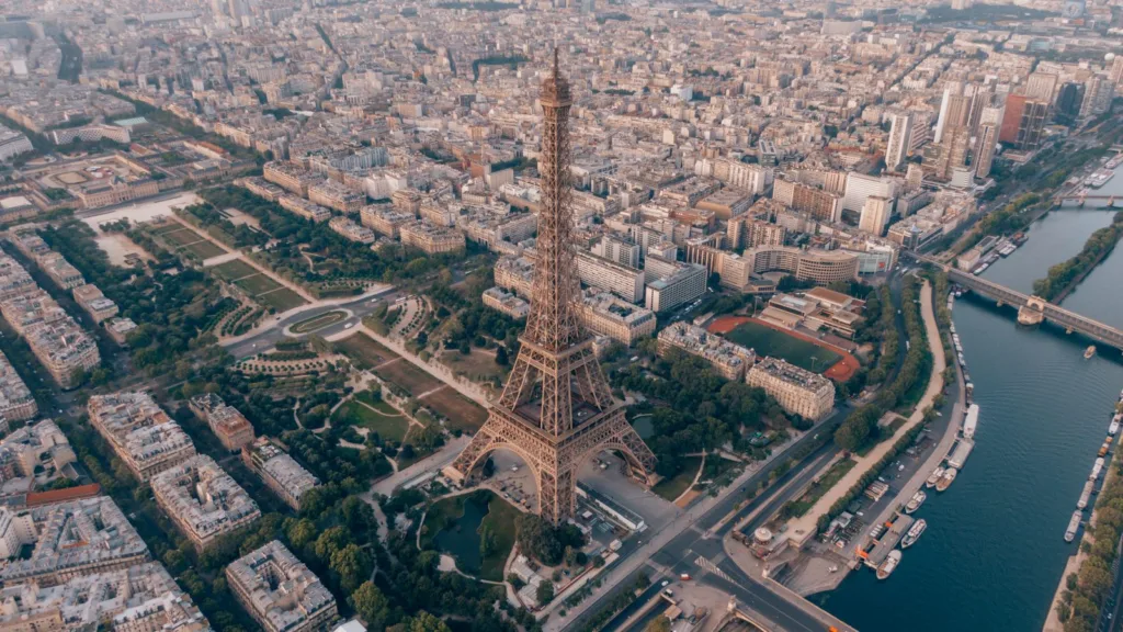 Aerial view of Paris in early light, with the Eiffel Tower, its gardens and the Seine