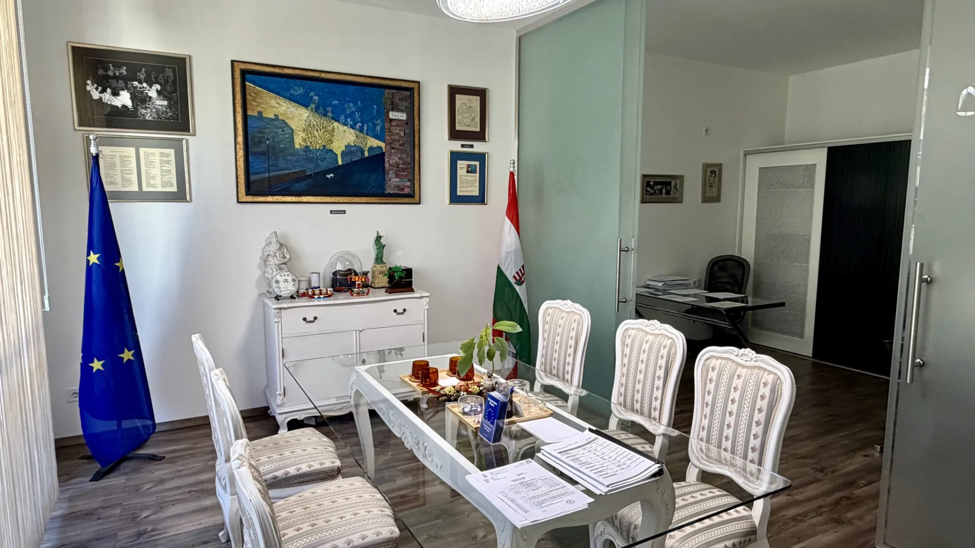 Westbridge Consulting meeting room in Budapest, with the EU and Hungarian flags and a glass meeting table