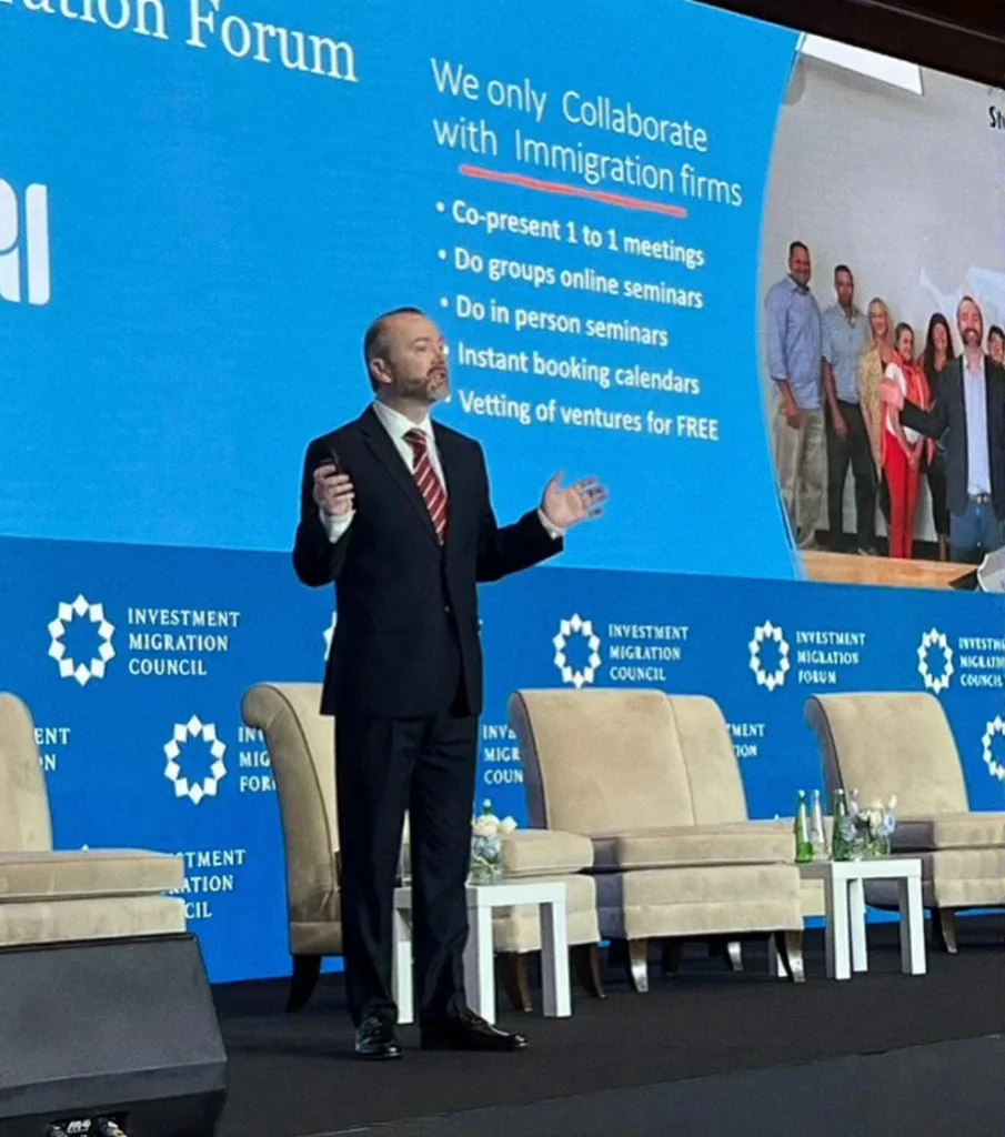 Slava Apel presenting on stage at the Investment Migration Forum